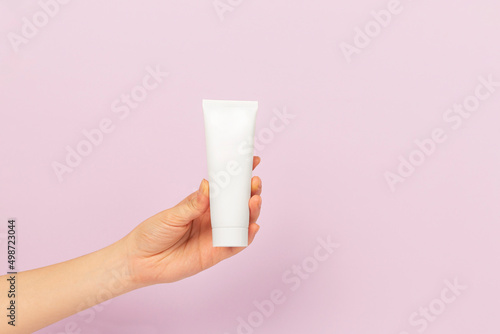 girl holding tube of cream 
