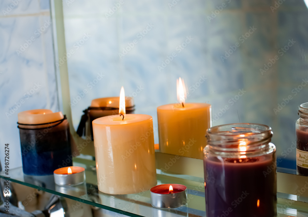 Concept of spa treatment in salon. Natural organic oil, towel, candles as decor. Atmosphere of relax, serenity and pleasure. Anti-stress and detox procedure. Luxury lifestyle. White wooden background Concept of spa treatment in salon. Natural organic oil, towel, candles as decor. Atmosphere of relax, serenity and pleasure. Anti-stress and detox procedure. Luxury lifestyle. White wooden background