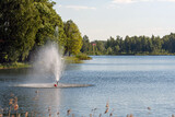 fountain in the lake, water pours from the pipes, splashes of water on the lake