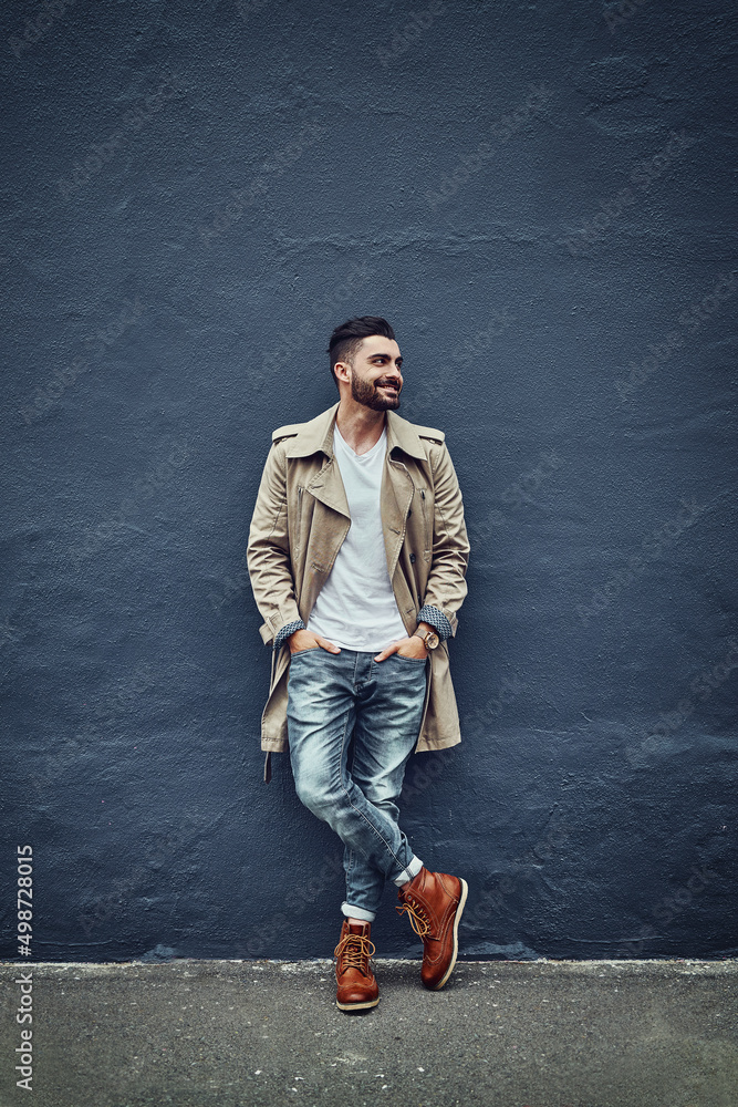 Style thats hot off the street. Shot of a fashionable young man wearing urban wear and posing against a gray wall.
