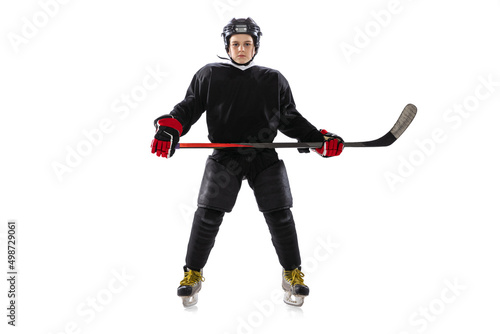 Full-length portrait of boy, child wearing special hockey game uniform, posing isolated over white studio background