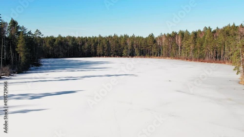 Wallpaper Mural View from the top of the Latvian lake in the Jurmala region, the lake is icy and frozen covered with snow. Aerial footage with the cinematic panoramic camera motion Torontodigital.ca
