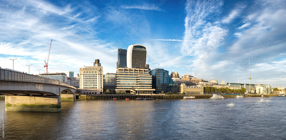 Panorama of London Bridge spanning the river Thames, with the City of London financial district and Tower of London.