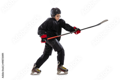 Active player. Sportive boy, child, hockey player in special uniform training, practising isolated over white studio background.