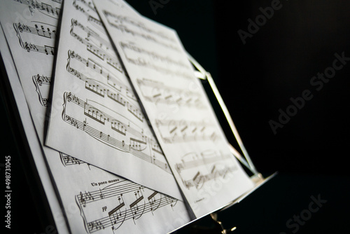 Music sheet on music stand with black background