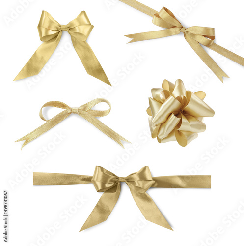 Set with beautiful golden ribbons tied in bows on white background