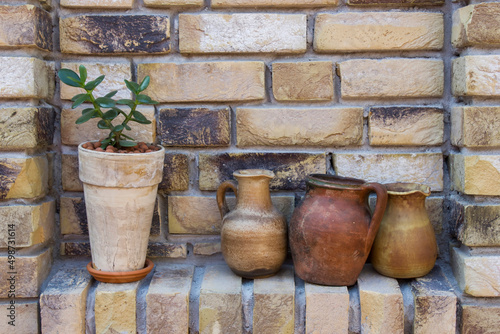 clay pots on a brick wall