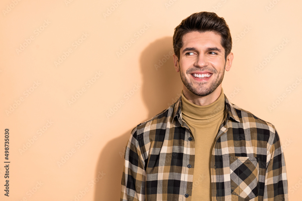 Portrait of cheerful guy promoter beaming smiling look away empty space isolated pastel color background Portrait of cheerful guy promoter beaming smiling look away empty space isolated pastel color background