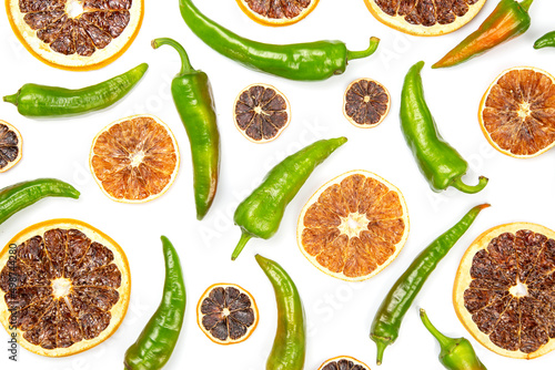 hot green peppers and dried citrus fruit on a white background. grocery organic flatley