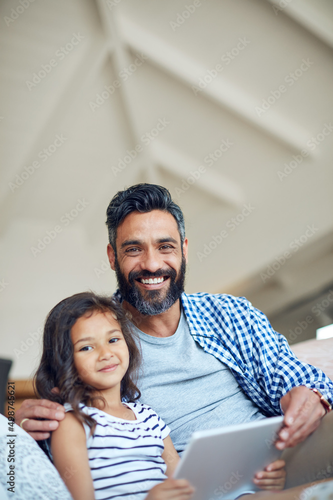 Theres so much to learn and discover online. Portrait of a father and daughter using a digital tablet together at home. Theres so much to learn and discover online. Portrait of a father and daughter using a digital tablet together at home.
