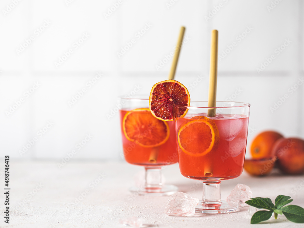 Red citrus photo of orange tangerine gin alcohol cocktail food photo on a table. Tasty citrus beverage banner copy space. Red citrus photo of orange tangerine gin alcohol cocktail food photo on a table. Tasty citrus beverage banner copy space.
