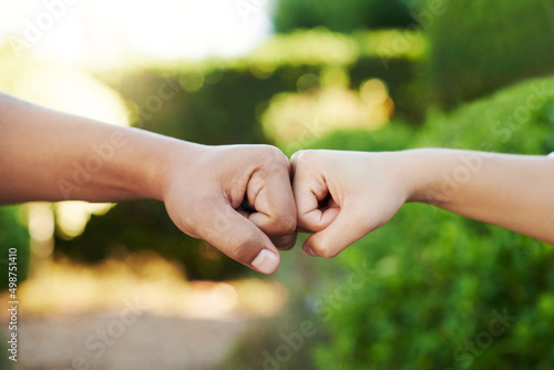 Theyre united. Cropped shot of an unrecognizable couple fist bumping in their yard at home. © Jeff B/peopleimages.com