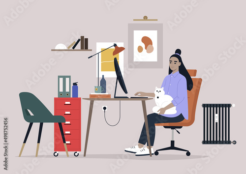 A young female Asian character working with a cat on their lap, home office interior