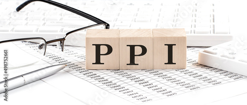 PPI written on wooden cube with keyboard , calculator, chart,glasses.Business concept photo