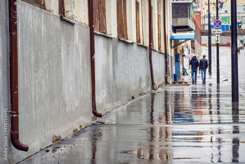 A fragment of an alley in cloudy weather in the rain