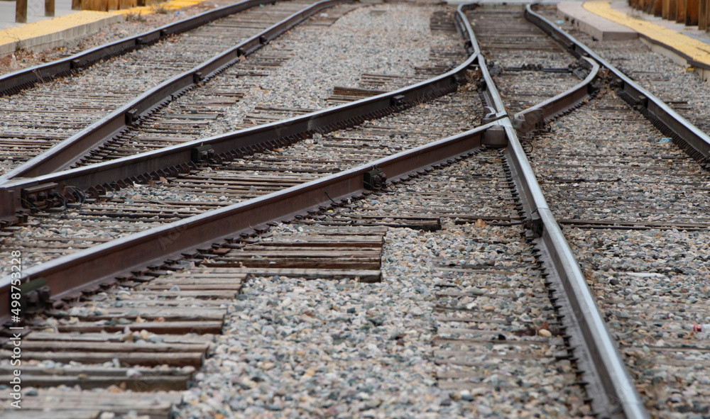 metal railroad tracks straight and curved lines converging into each