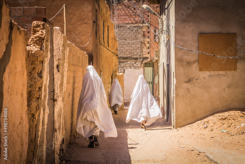 Muslim women on the narrow street of ancient Gardaia city, M'Zab valley, Algeria