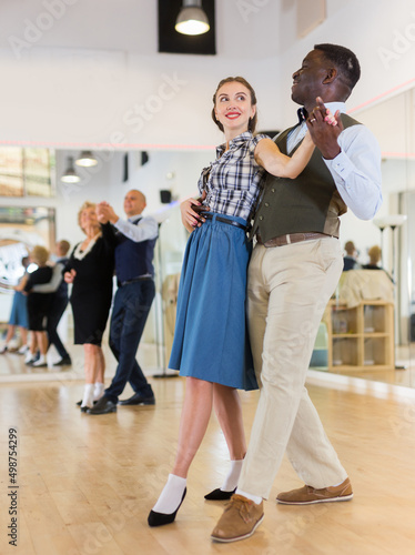 Woman with american man practising ballroom dancing