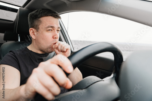 a sleepy and yawning man drives a car on the highway © andrey