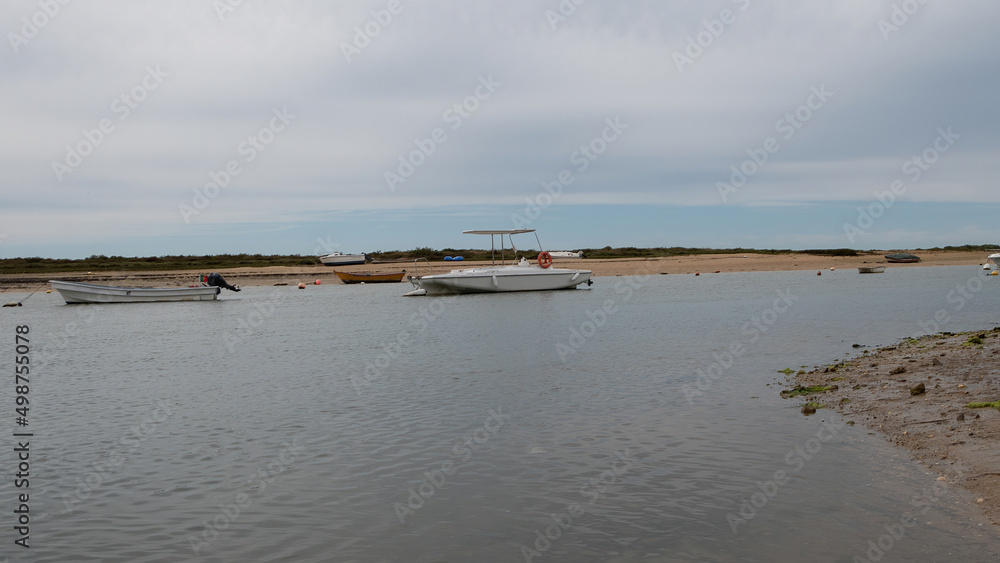 New and old fishing boats on the river bank