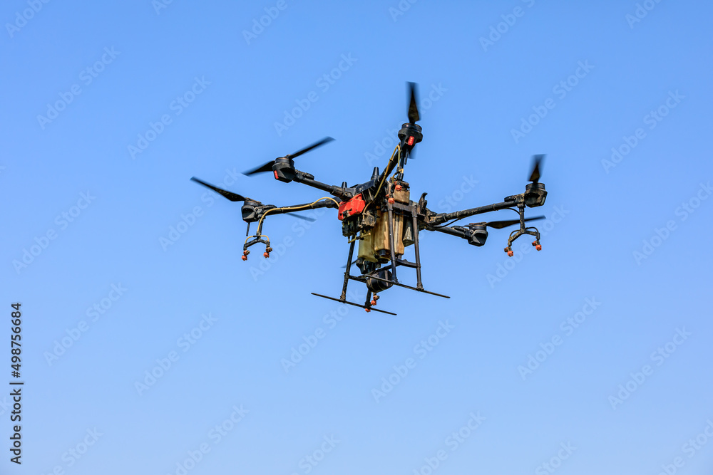 Agricultural drone spraying pesticides. Drones are used in agriculture. Agricultural drone spraying pesticides. Drones are used in agriculture.