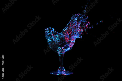 Big splash in one single glass isolated on black background