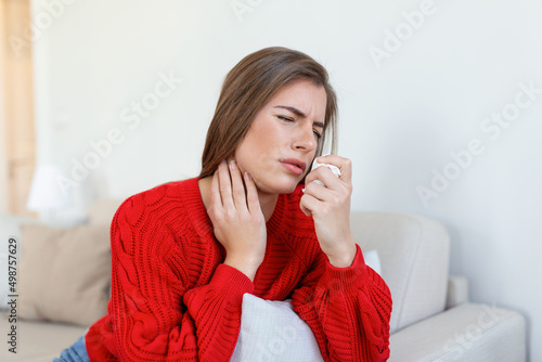 Sick woman sit on bed feel unhealthy blowing running nose, ill young woman suffering from rhinitis snuffles, having respiratory infection, get flue need medication