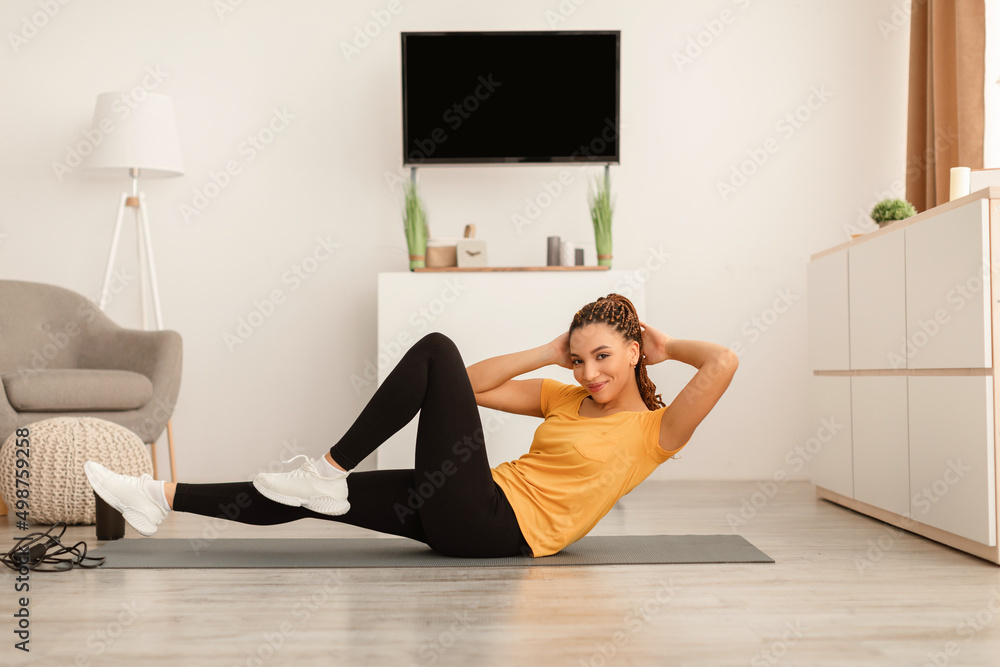 African Woman Exercising Doing Elbow To Knee Abs Crunches Indoor