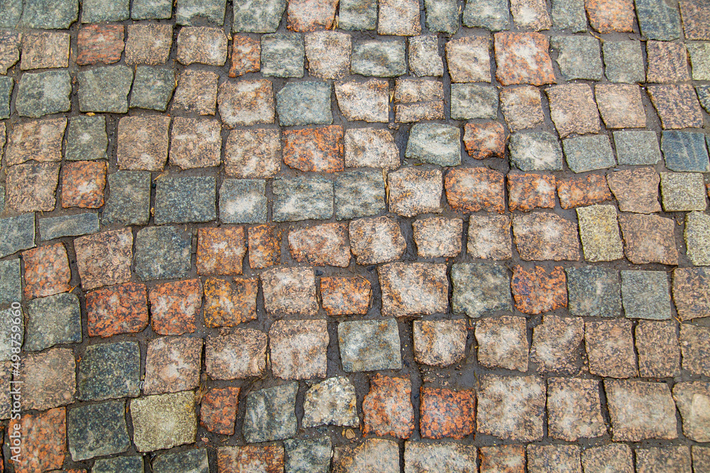 Obraz premium The background of the sidewalk is made of rectangular natural stone of gray lilac color. Texture backgrounds for graphic design. Abstract wallpaper.