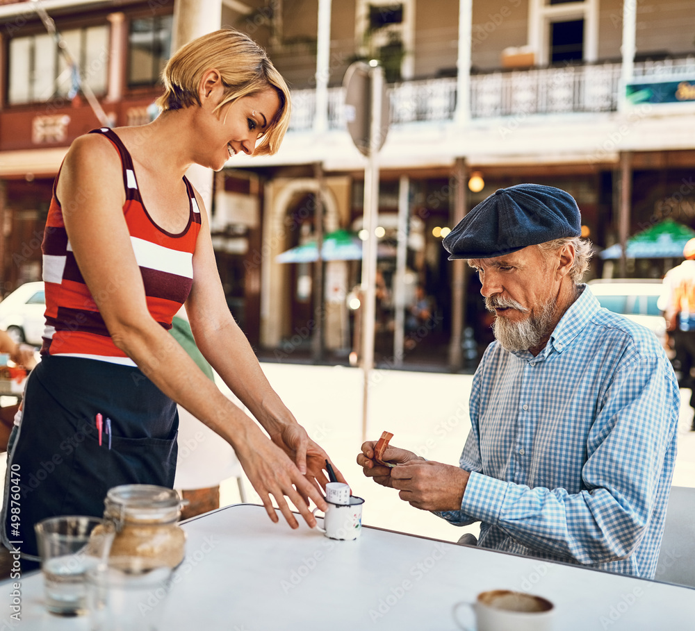 Hes always generous with his tip. Shot of a friendly waitress serving a senior man at a table outside a cafe. Hes always generous with his tip. Shot of a friendly waitress serving a senior man at a table outside a cafe.