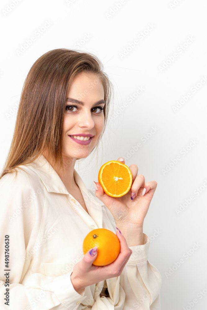 Young Caucasian smiling woman with slices orange over isolated white background Young Caucasian smiling woman with slices orange over isolated white background