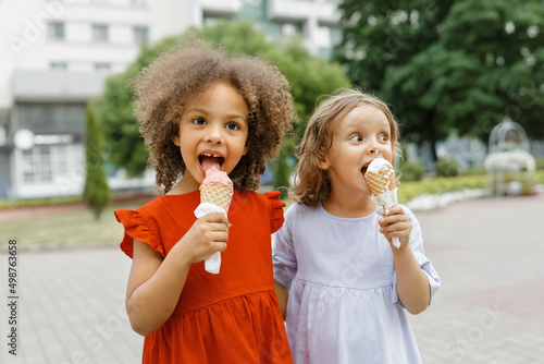 a two girl friends eats ice cream on a hot summer day. Ice cream in a waffle cone
