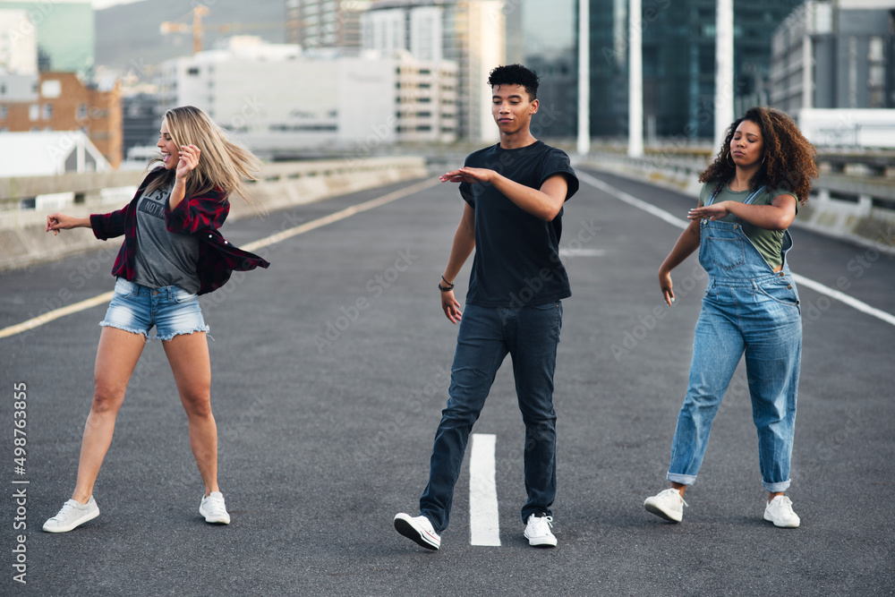 Theyre making moves in the city. Full length shot of a group of dancers dancing in the street.