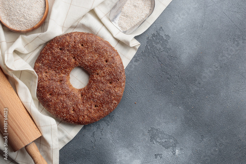 Reikäleipä - traditional finnish rye bread on a gray concrete background photo