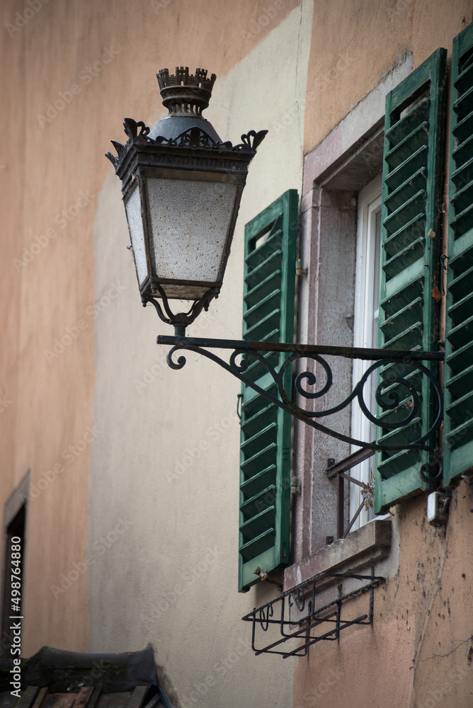 Closeup of vintage street light on house facade in the street