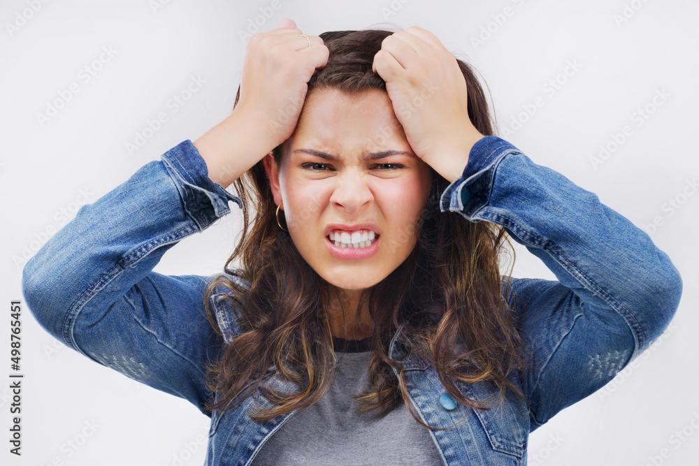 This stress is killing me. Studio portrait of an attractive young woman looking stressed out against a grey background. This stress is killing me. Studio portrait of an attractive young woman looking stressed out against a grey background.