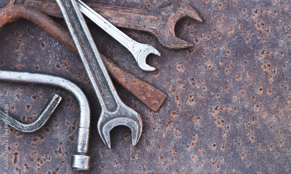 Old wrench spanner and garage tools on rusty background Old wrench spanner and garage tools on rusty background