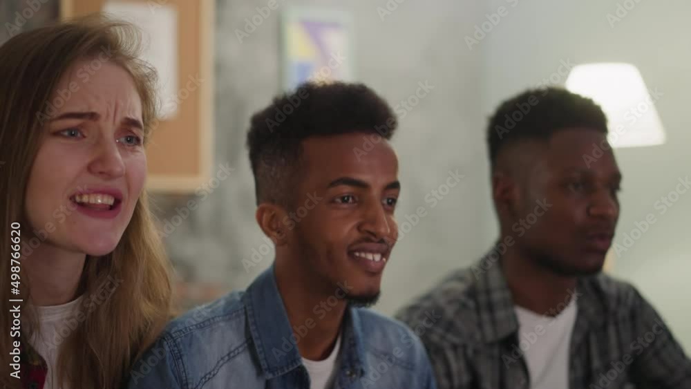 Smiling black guy with emotional woman and friend watches baseball game at home closeup slow motion. Ballgame lovers enjoy championship together Smiling black guy with emotional woman and friend watches baseball game at home closeup slow motion. Ballgame lovers enjoy championship together