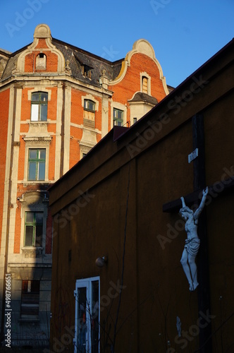 Light and shadow side of the street. Corner with Crucifixion of Christ. Myslowice, Poland. photo