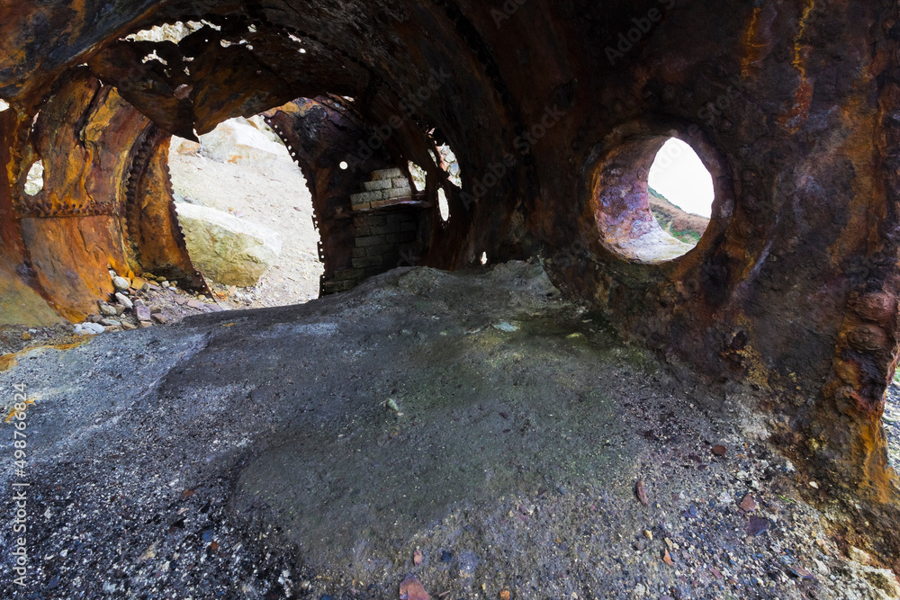 Creative view from inside a discarded boiler drum on the site of the former Victorian brickworks at Porth Wen, Isle of Anglesey, North Wales