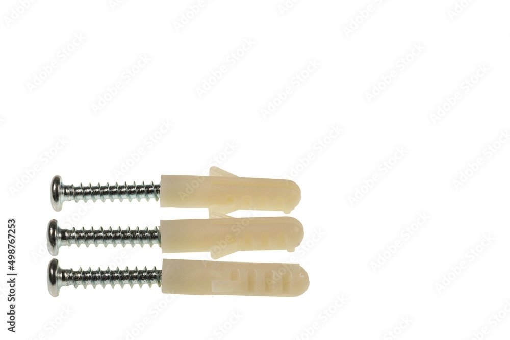Close up view of screws screwed into white plastic screw caps isolated on white background. Close up view of screws screwed into white plastic screw caps isolated on white background.