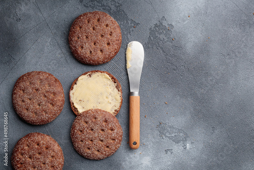 Ruisleipa - traditional Finnish rye bread with butter on a gray concrete photo