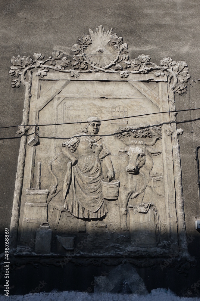 Relief sculpture on the building wall in Szopienice (ordinary scene in the image). Katowice, Poland.