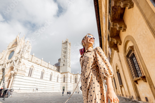 Woman standing in front of Siena cathedral. Traveling old towns of Tuscany region in Italy. Concept of visiting famous italian landmarks © rh2010