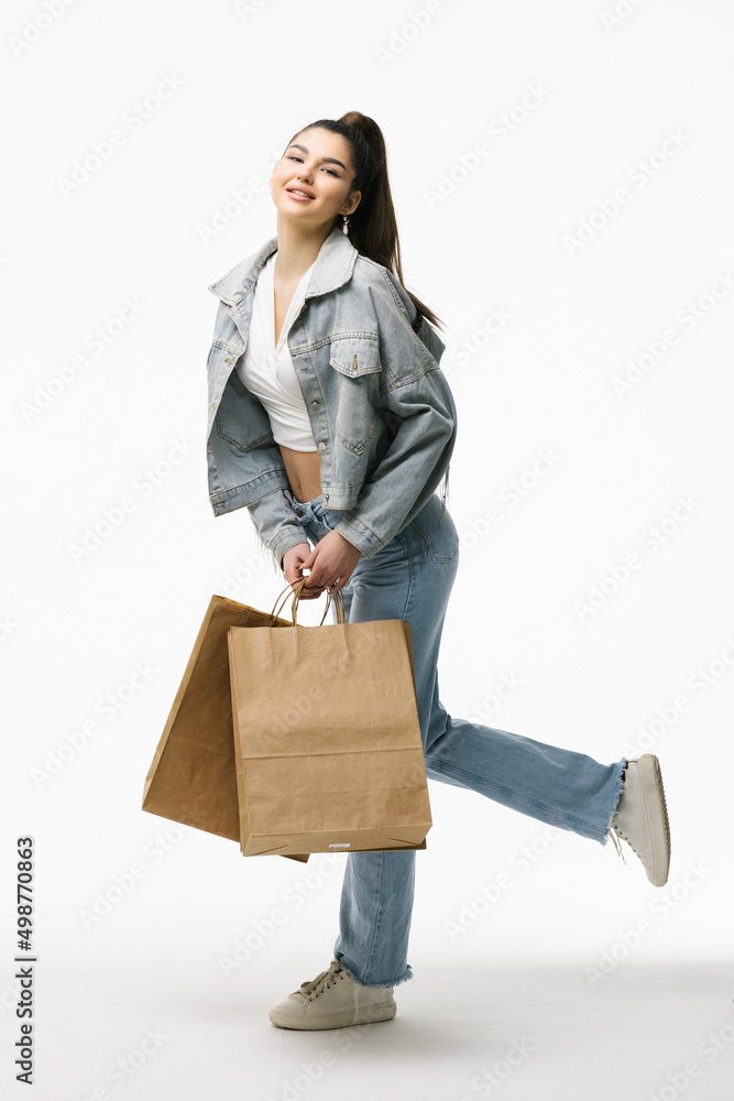 Happy young woman with shopping bags isolated on white background Happy young woman with shopping bags isolated on white background