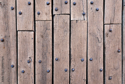 Old wooden flooring made of planks and rusty rivets.