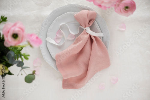 Fototapeta Naklejka Na Ścianę i Meble -  Elegant pink linen napkin on the white dish