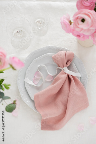 Elegant pink linen napkin on the white dish