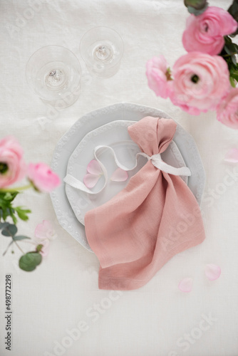 Elegant pink linen napkin on the white dish