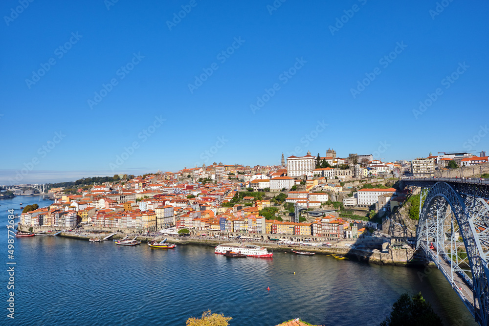 The old town of Porto with the river Douro and the famous iron bridge on a sunny day